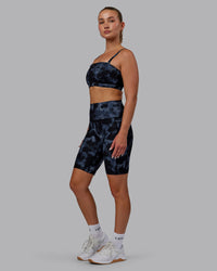 Woman wearing Fusion Ultra High-Rise 9" Short Pockets - Tie Dye-Midnight | Model:Halle | Size:S