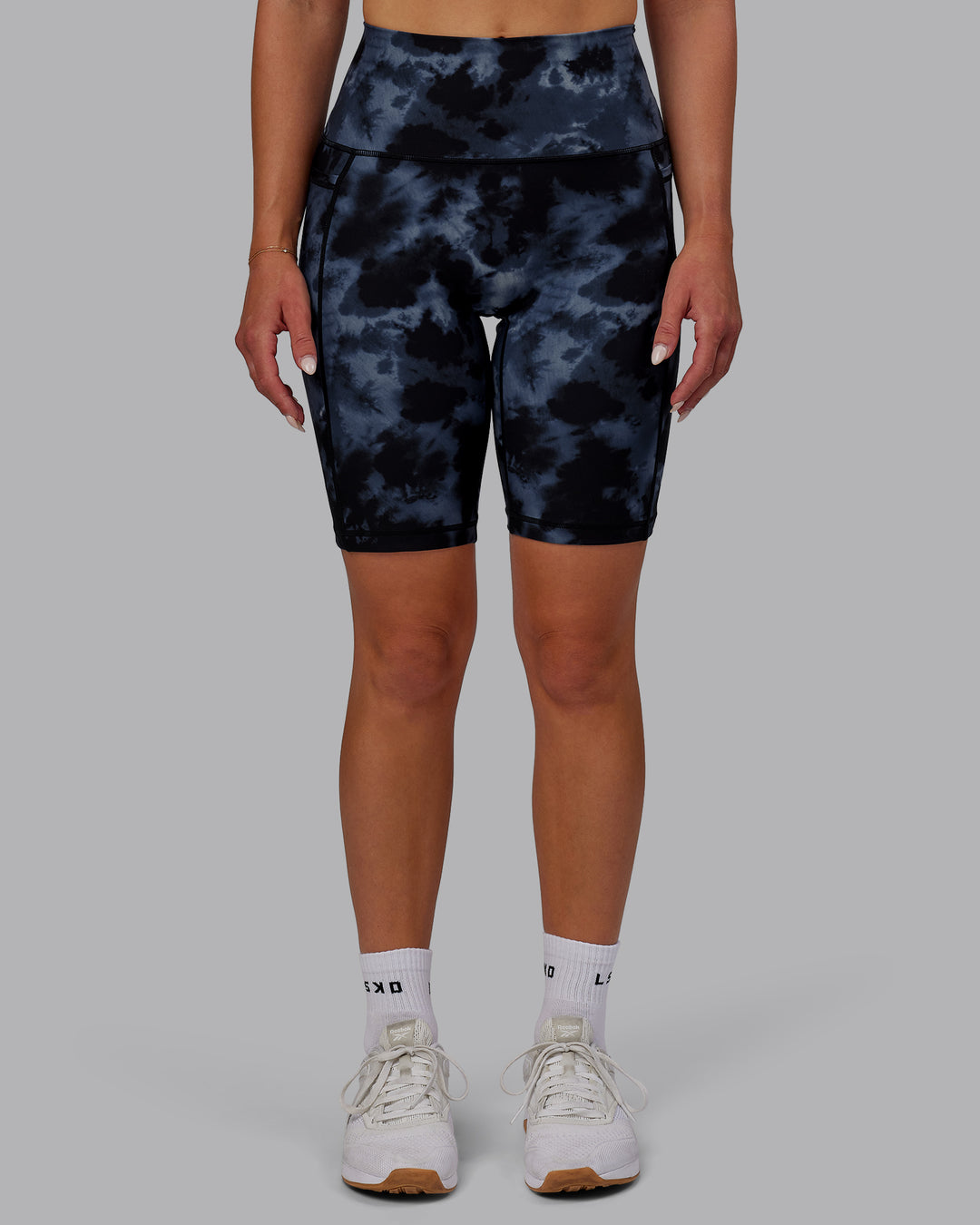 Woman wearing Fusion Ultra High-Rise 9&quot; Short Pockets - Tie Dye-Midnight | Model:Halle | Size:S