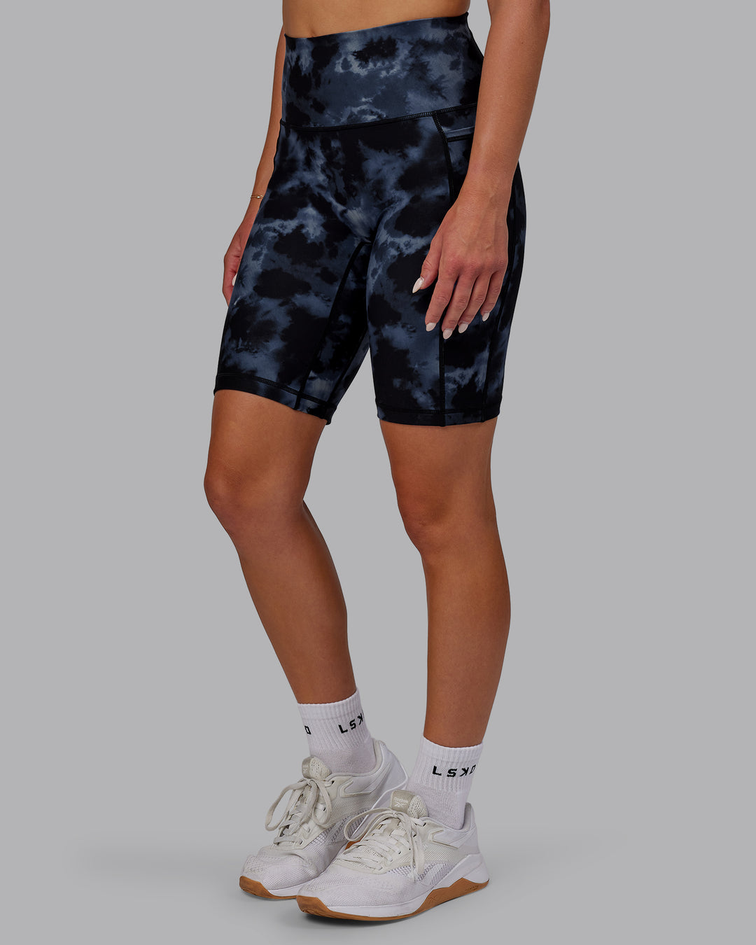 Woman wearing Fusion Ultra High-Rise 9&quot; Short Pockets - Tie Dye-Midnight | Model:Halle | Size:S