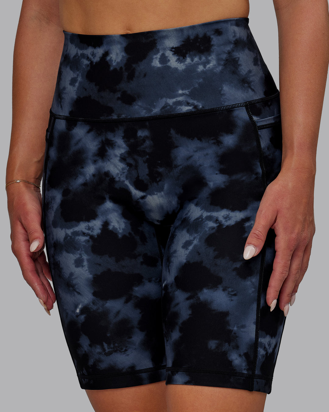 Woman wearing Fusion Ultra High-Rise 9&quot; Short Pockets - Tie Dye-Midnight | Model:Halle | Size:S