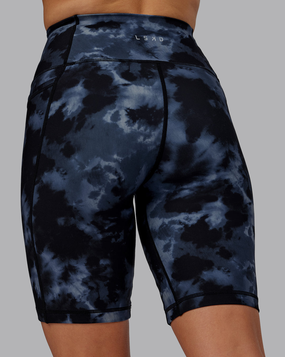 Woman wearing Fusion Ultra High-Rise 9&quot; Short Pockets - Tie Dye-Midnight | Model:Halle | Size:S