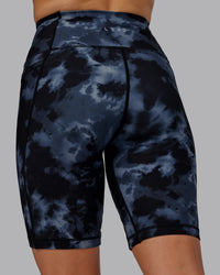 Woman wearing Fusion Ultra High-Rise 9" Short Pockets - Tie Dye-Midnight | Model:Halle | Size:S