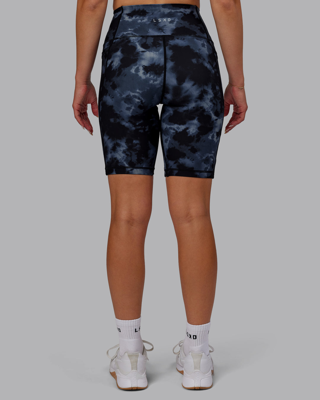 Woman wearing Fusion Ultra High-Rise 9&quot; Short Pockets - Tie Dye-Midnight | Model:Halle | Size:S
