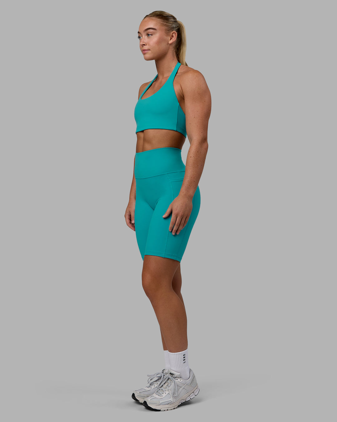 Woman wearing Fusion Ultra High-Rise 9&quot; Short Pockets - Uplift Blue | Model:Monique | Size:S