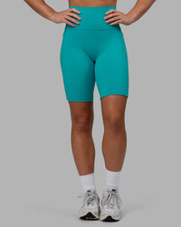Woman wearing Fusion Ultra High-Rise 9" Short Pockets - Uplift Blue | Model:Monique | Size:S