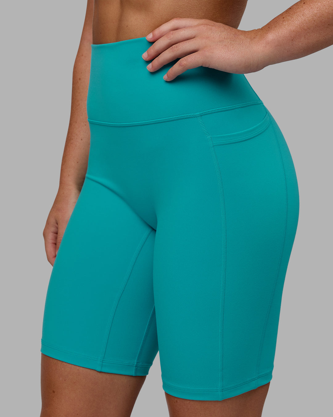 Woman wearing Fusion Ultra High-Rise 9&quot; Short Pockets - Uplift Blue | Model:Monique | Size:S