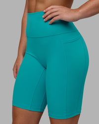 Woman wearing Fusion Ultra High-Rise 9" Short Pockets - Uplift Blue | Model:Monique | Size:S