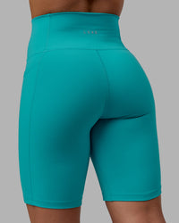 Woman wearing Fusion Ultra High-Rise 9" Short Pockets - Uplift Blue | Model:Monique | Size:S