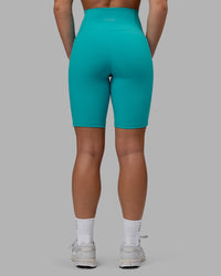 Woman wearing Fusion Ultra High-Rise 9" Short Pockets - Uplift Blue | Model:Monique | Size:S