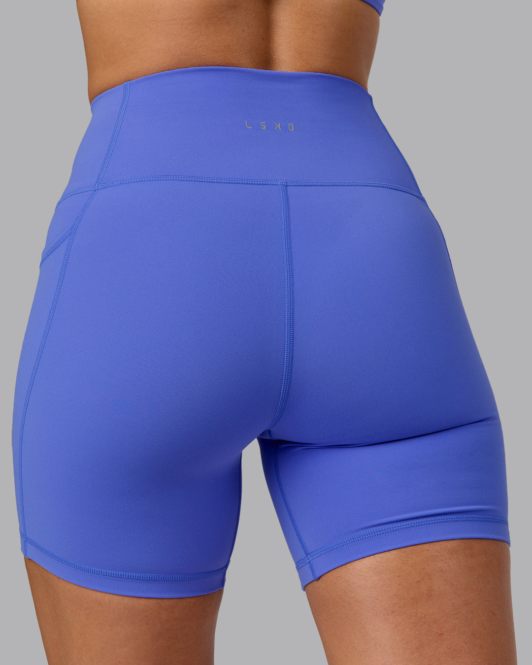 Woman wearing Fusion Ultra High-Rise 6&quot; Short Pockets - Baja Blue | Model:Sophie | Size:S