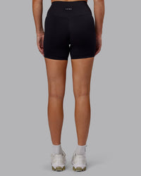 Woman wearing Fusion Ultra High-Rise 6" Short - Black | Set:true | Angle:back | Model:Hannah | Size:S