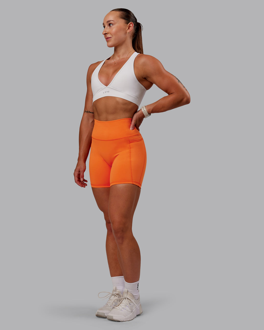 Woman wearing Fusion Ultra High-Rise 6&quot; Short Pockets - Mandarin | Model:Amber | Size:S