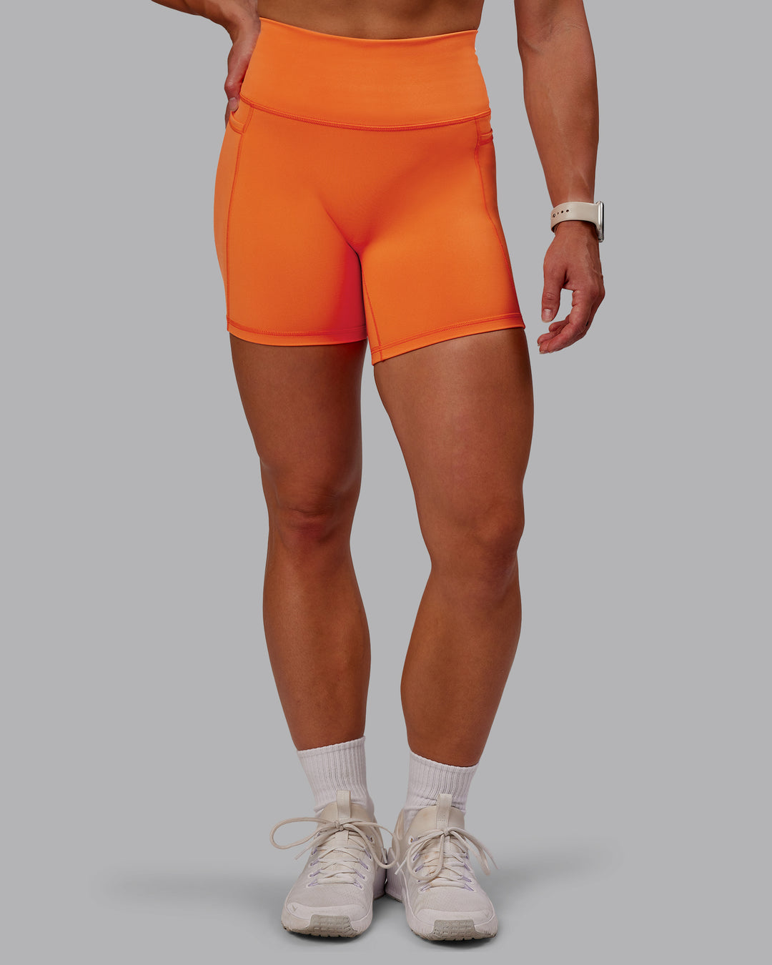 Woman wearing Fusion Ultra High-Rise 6&quot; Short Pockets - Mandarin | Model:Amber | Size:S