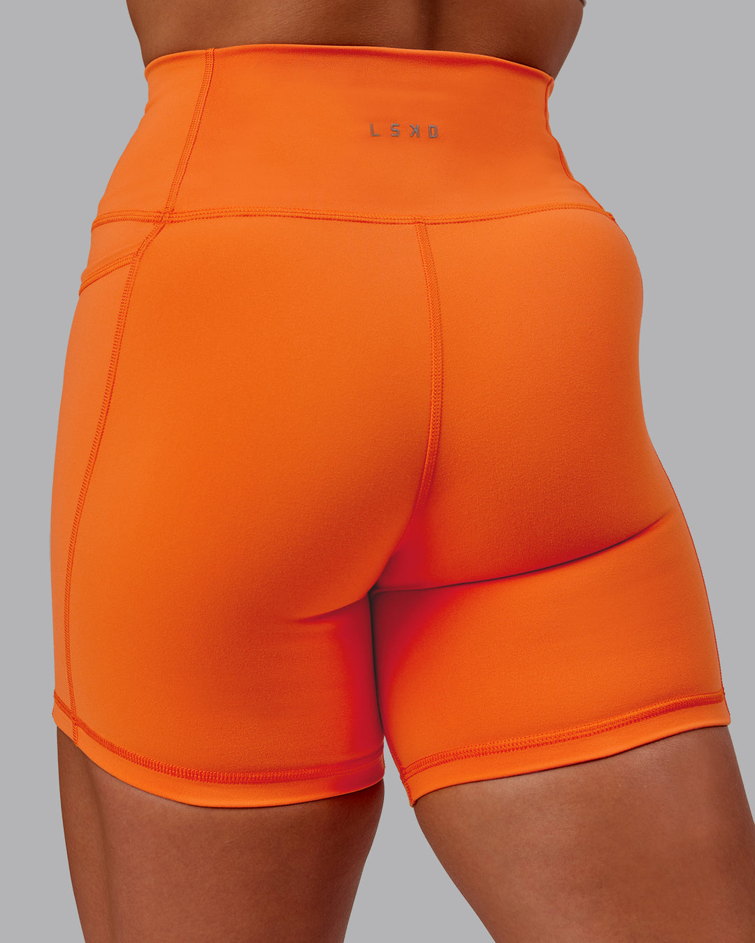 Woman wearing Fusion Ultra High-Rise 6&quot; Short Pockets - Mandarin | Model:Amber | Size:S