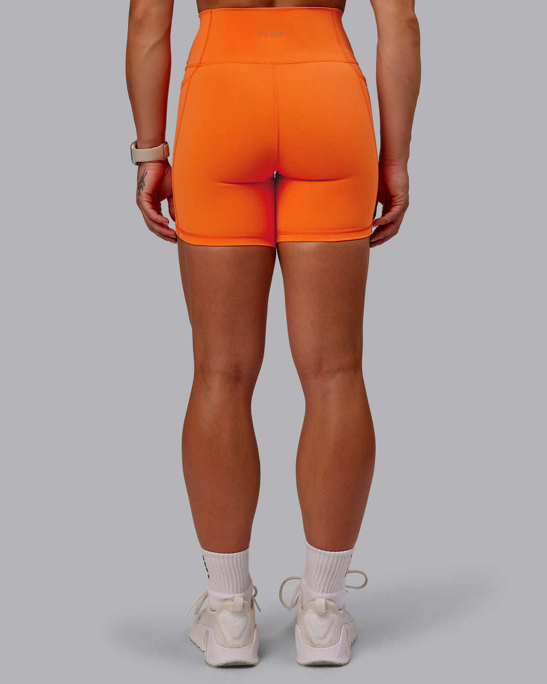 Woman wearing Fusion Ultra High-Rise 6&quot; Short Pockets - Mandarin | Model:Amber | Size:S