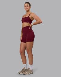 Woman wearing Fusion Ultra High-Rise 6" Short Pockets - Cordovan | Model:Chloe | Size:XS