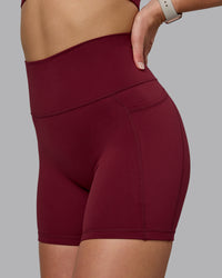 Woman wearing Fusion Ultra High-Rise 6" Short Pockets - Cordovan | Model:Chloe | Size:XS