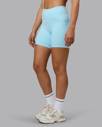 Woman wearing Fusion Ultra High-Rise 6" Short Pockets - Crystal Blue | Set:true | Angle:side | Model:Sophie | Size:S