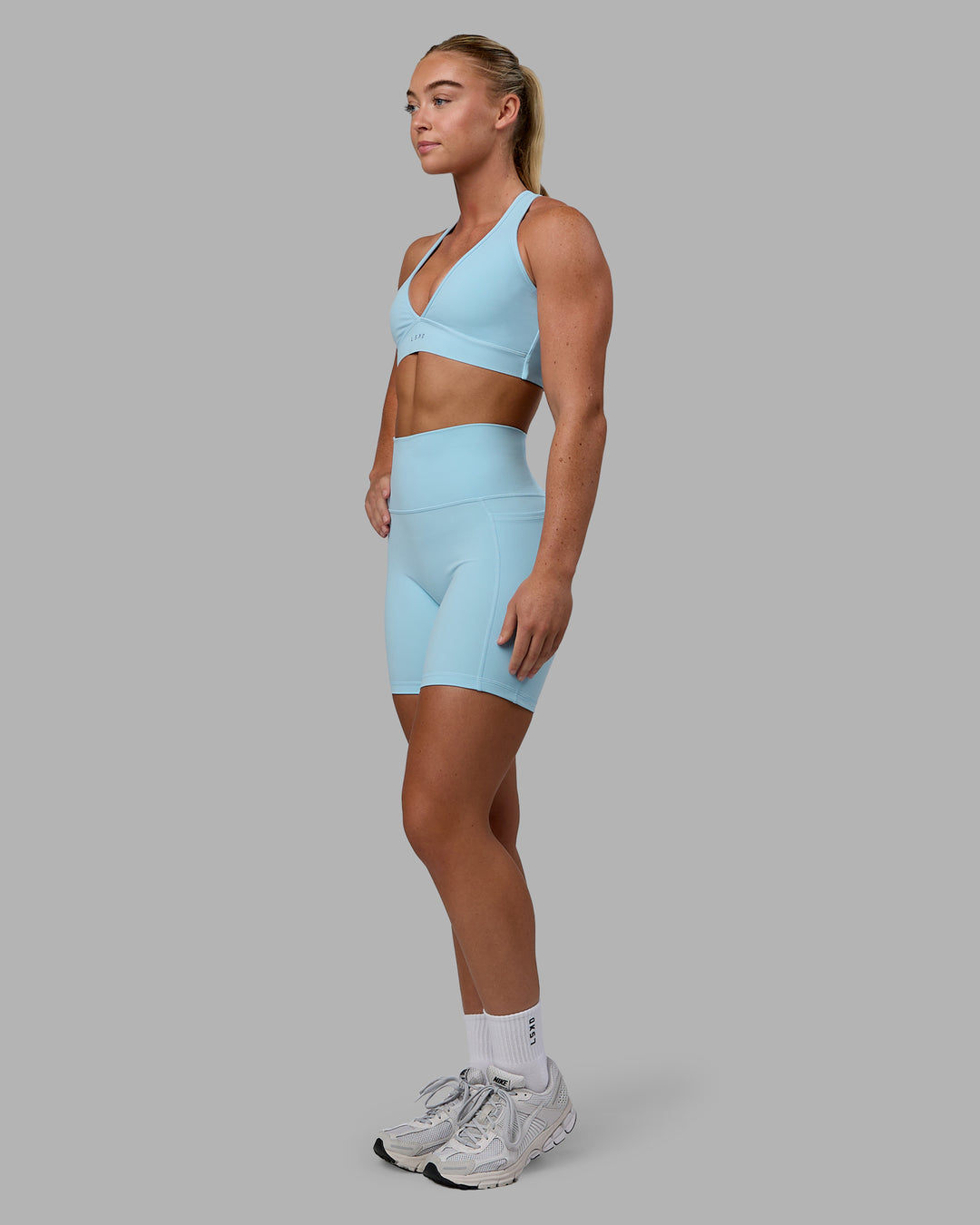 Woman wearing Fusion Ultra High-Rise 6&quot; Short Pockets - Glacial Blue | Model:Monique | Size:S