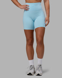 Woman wearing Fusion Ultra High-Rise 6" Short Pockets - Glacial Blue | Model:Monique | Size:S