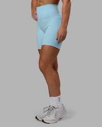 Woman wearing Fusion Ultra High-Rise 6" Short Pockets - Glacial Blue | Model:Monique | Size:S