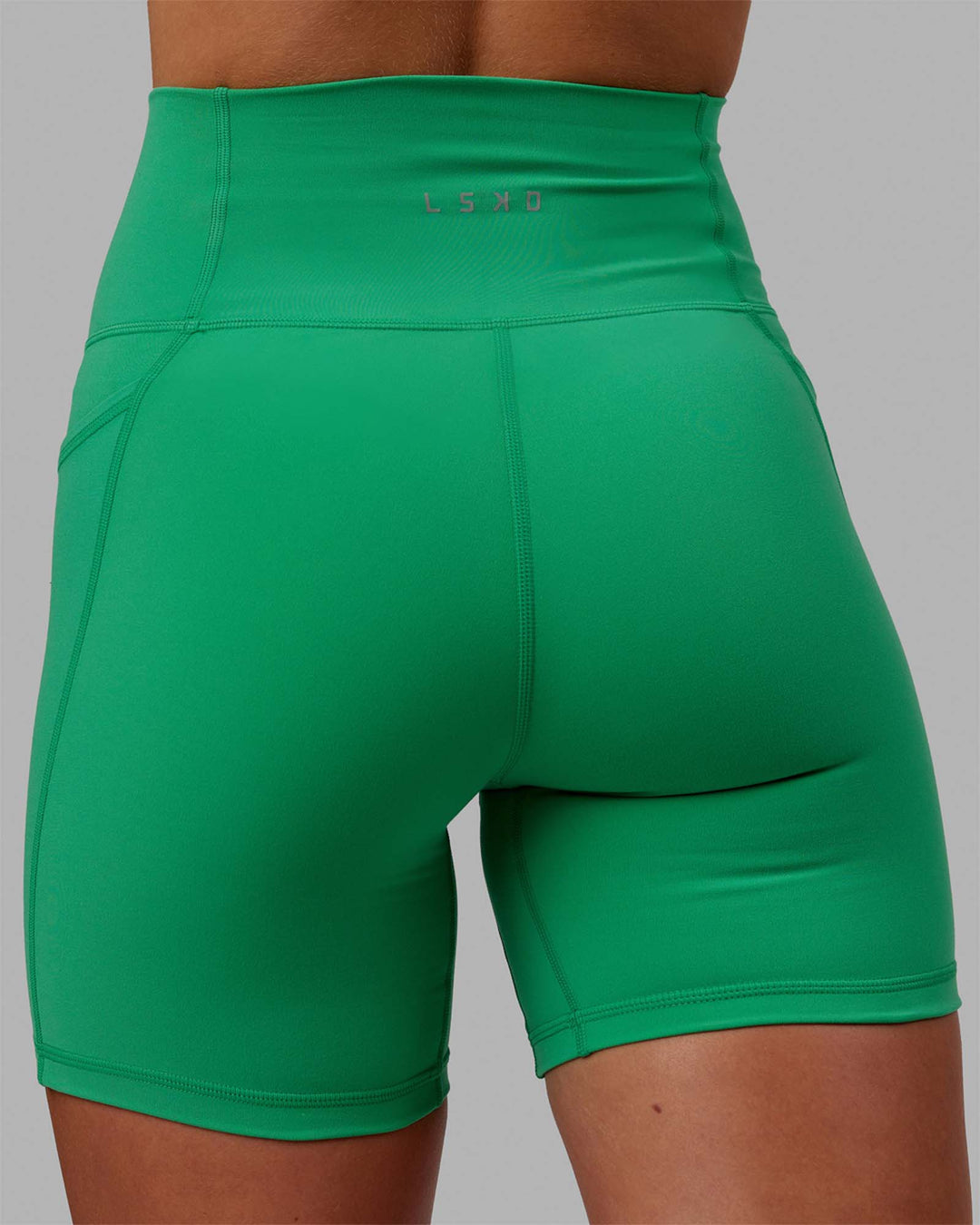 Woman wearing Fusion Ultra High-Rise 6&quot; Short Pockets - Holly Green | Model:Emilia | Size:XS
