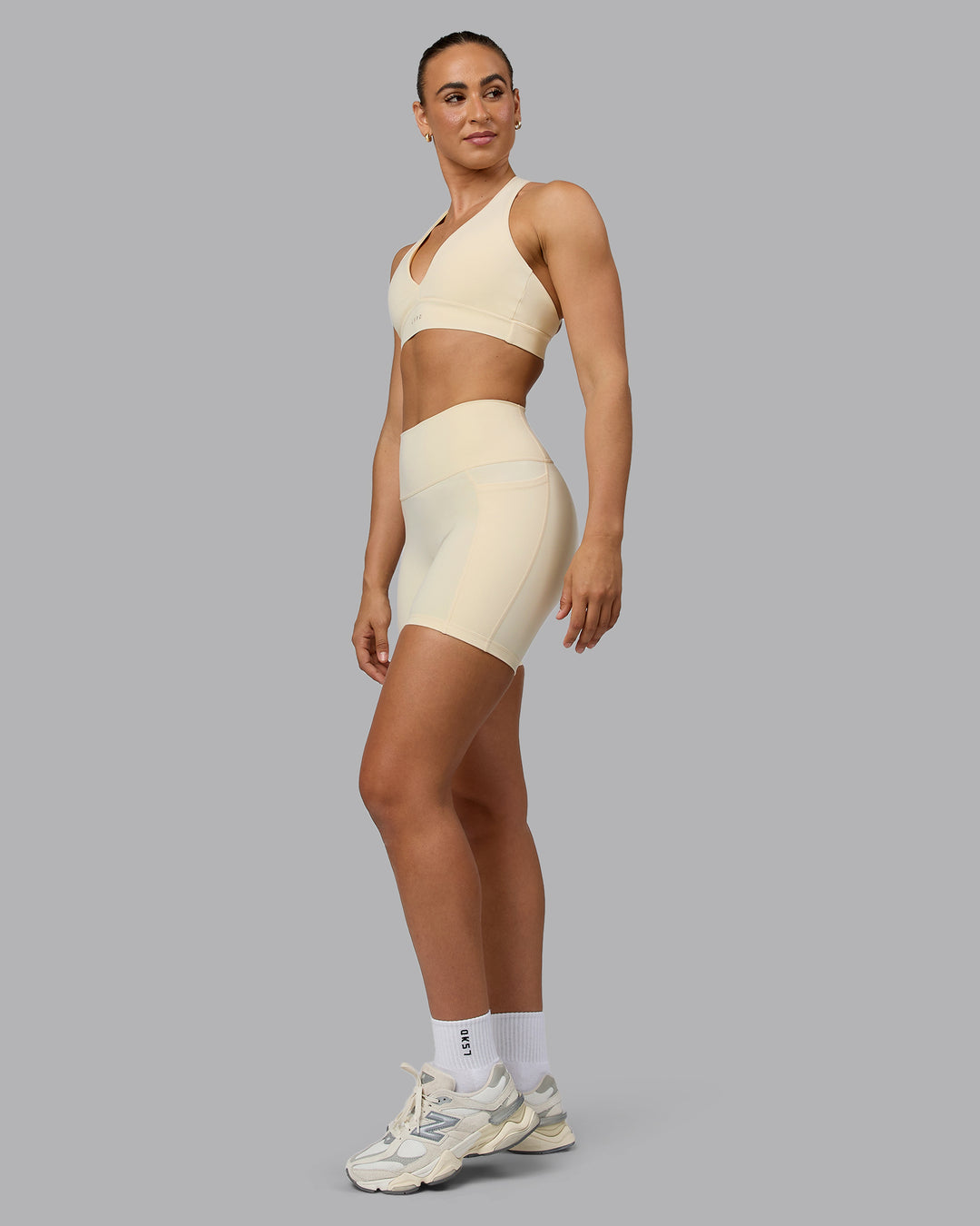 Woman wearing Fusion Ultra High-Rise 6&quot; Short Pockets - Ivory | Model:Sophie | Size:S