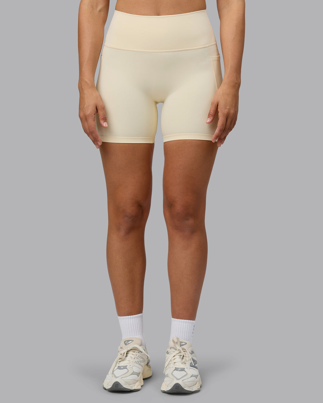 Woman wearing Fusion Ultra High-Rise 6&quot; Short Pockets - Ivory | Model:Sophie | Size:S