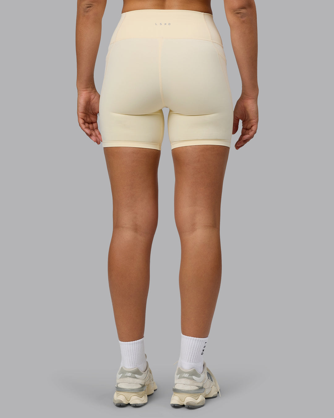 Woman wearing Fusion Ultra High-Rise 6&quot; Short Pockets - Ivory | Model:Sophie | Size:S