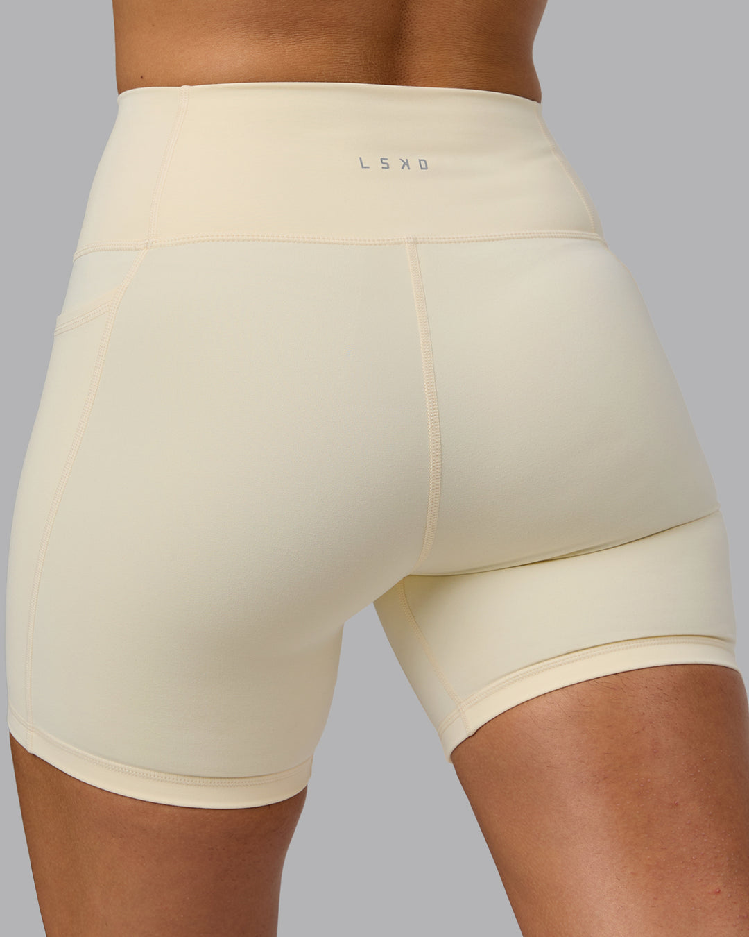 Woman wearing Fusion Ultra High-Rise 6&quot; Short Pockets - Ivory | Model:Sophie | Size:S