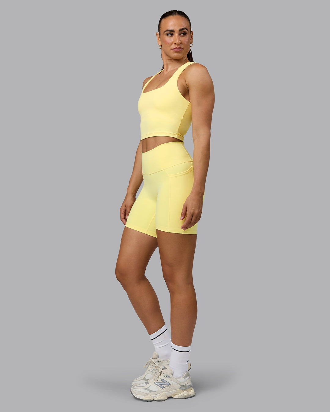Woman wearing Fusion Ultra High-Rise 6&quot; Short Pockets - Lemon | Model:Sophie | Size:S