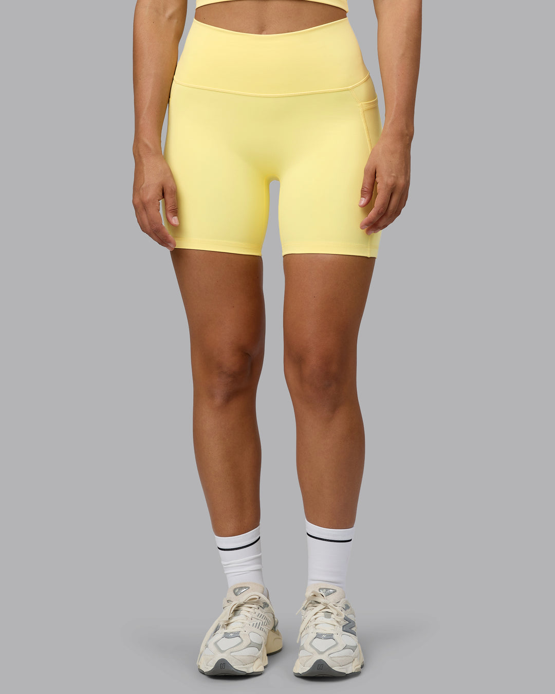 Woman wearing Fusion Ultra High-Rise 6&quot; Short Pockets - Lemon | Model:Sophie | Size:S