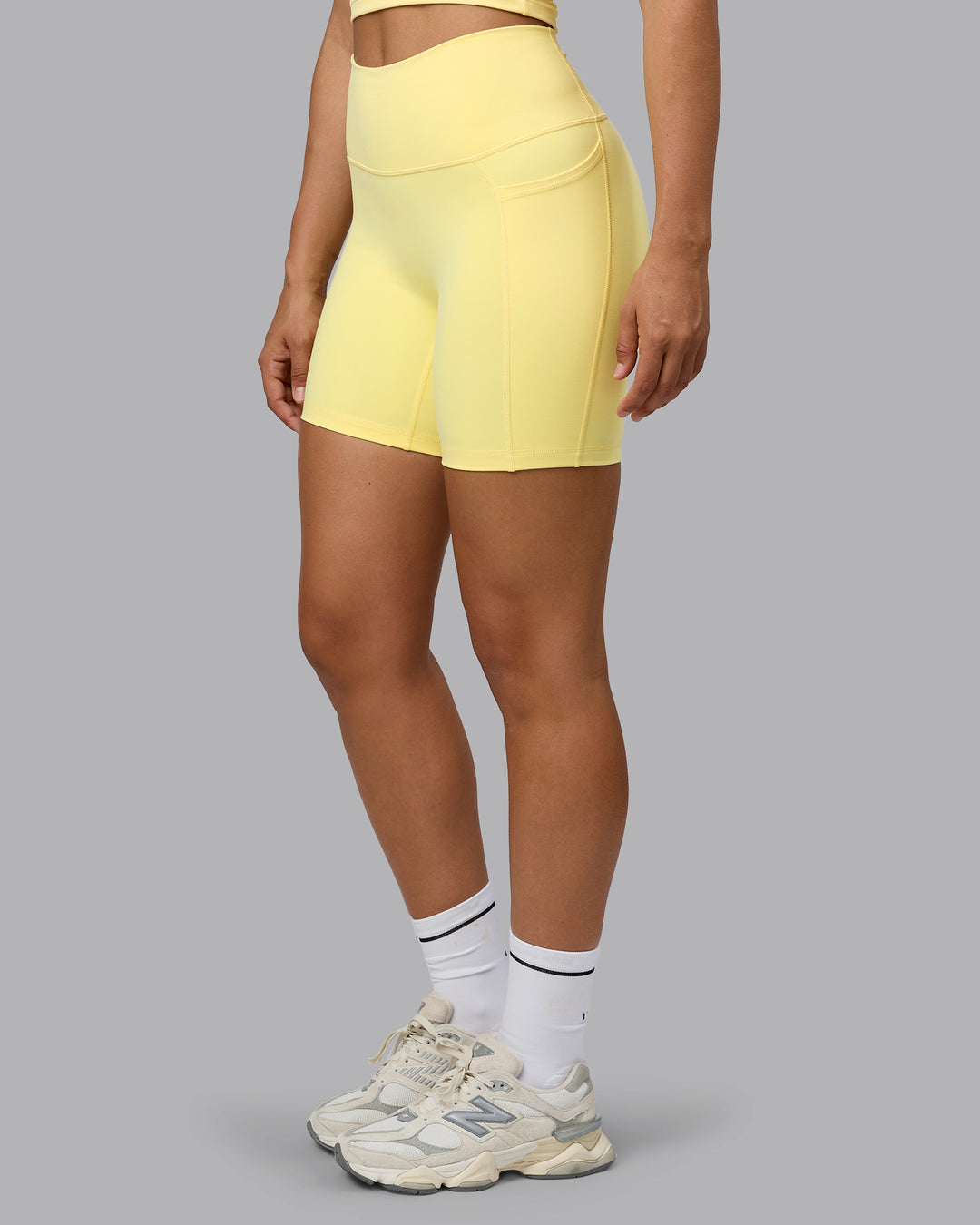 Woman wearing Fusion Ultra High-Rise 6&quot; Short Pockets - Lemon | Model:Sophie | Size:S