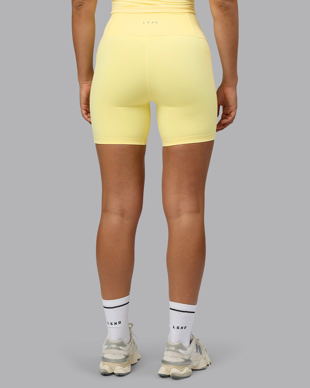 Woman wearing Fusion Ultra High-Rise 6&quot; Short Pockets - Lemon | Model:Sophie | Size:S