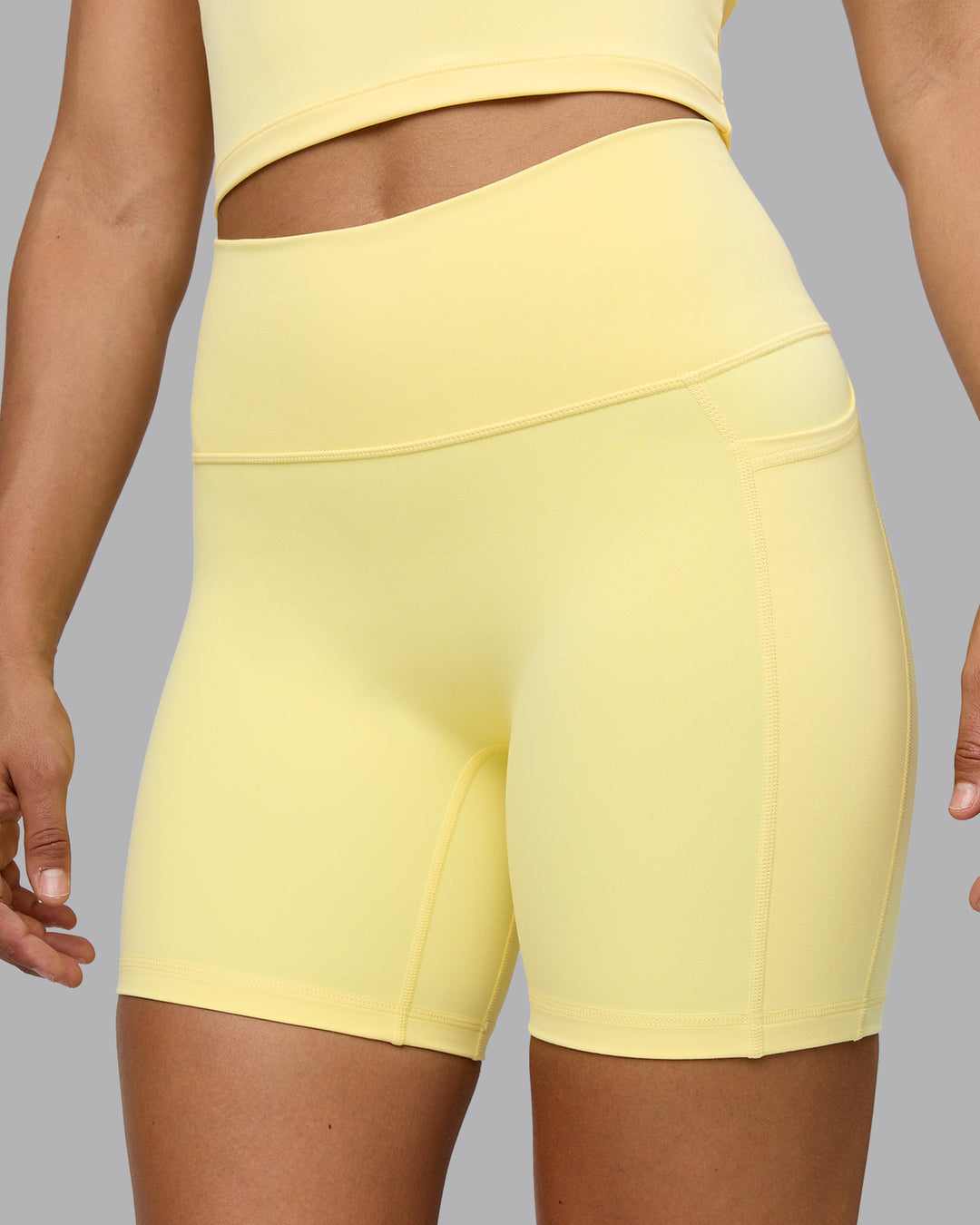 Woman wearing Fusion Ultra High-Rise 6&quot; Short Pockets - Lemon | Model:Sophie | Size:S