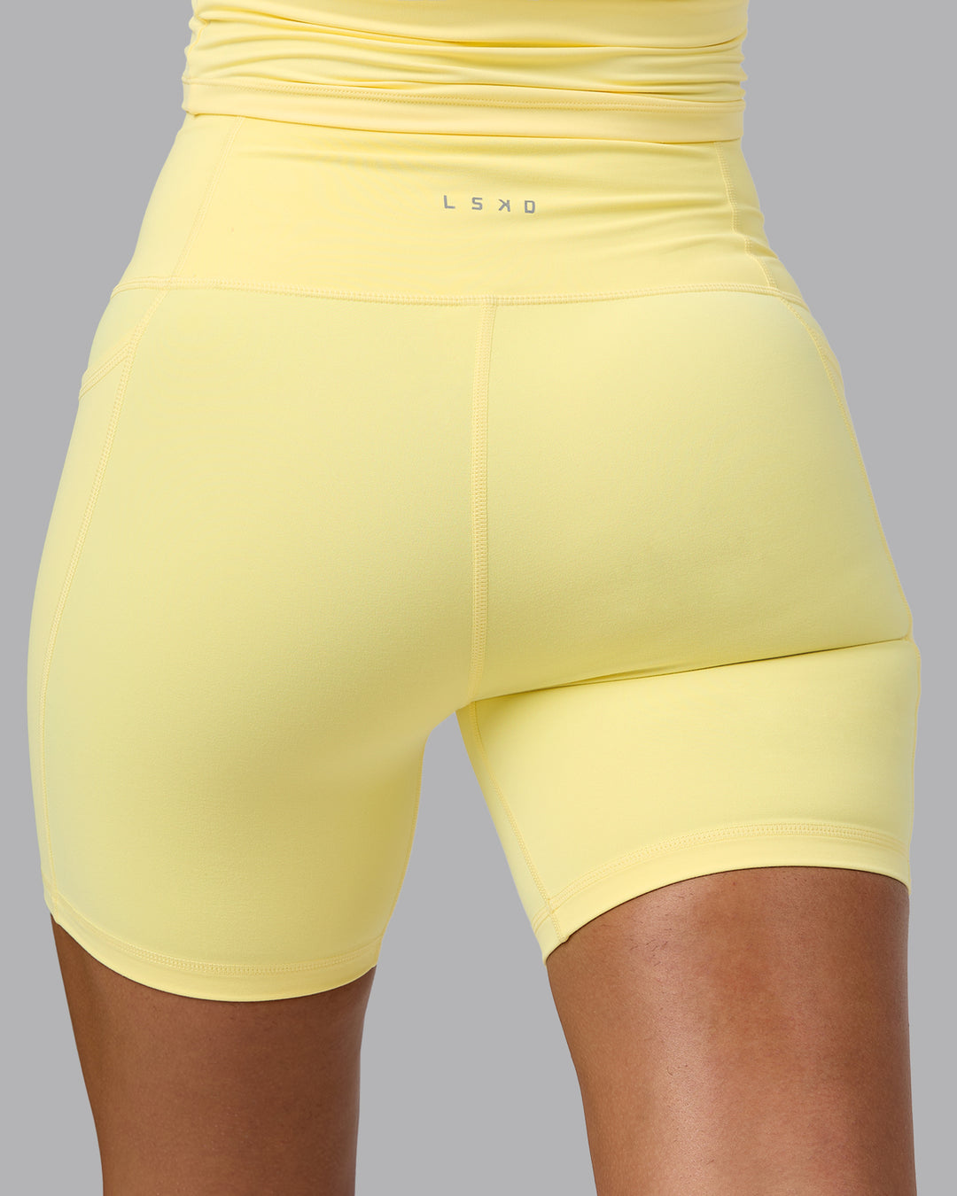 Woman wearing Fusion Ultra High-Rise 6&quot; Short Pockets - Lemon | Model:Sophie | Size:S
