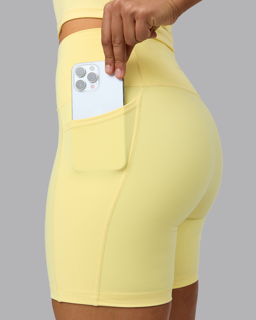 Woman wearing Fusion Ultra High-Rise 6&quot; Short Pockets - Lemon | Model:Sophie | Size:S