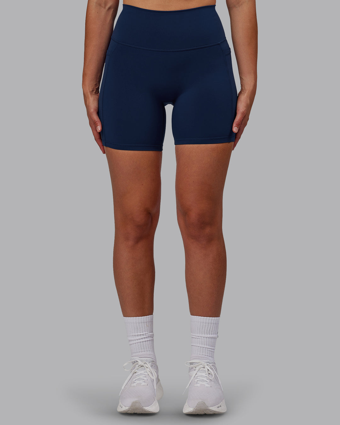 Woman wearing Fusion Ultra High-Rise 6&quot; Short Pockets - Future Navy | Model:Sophie | Size:S
