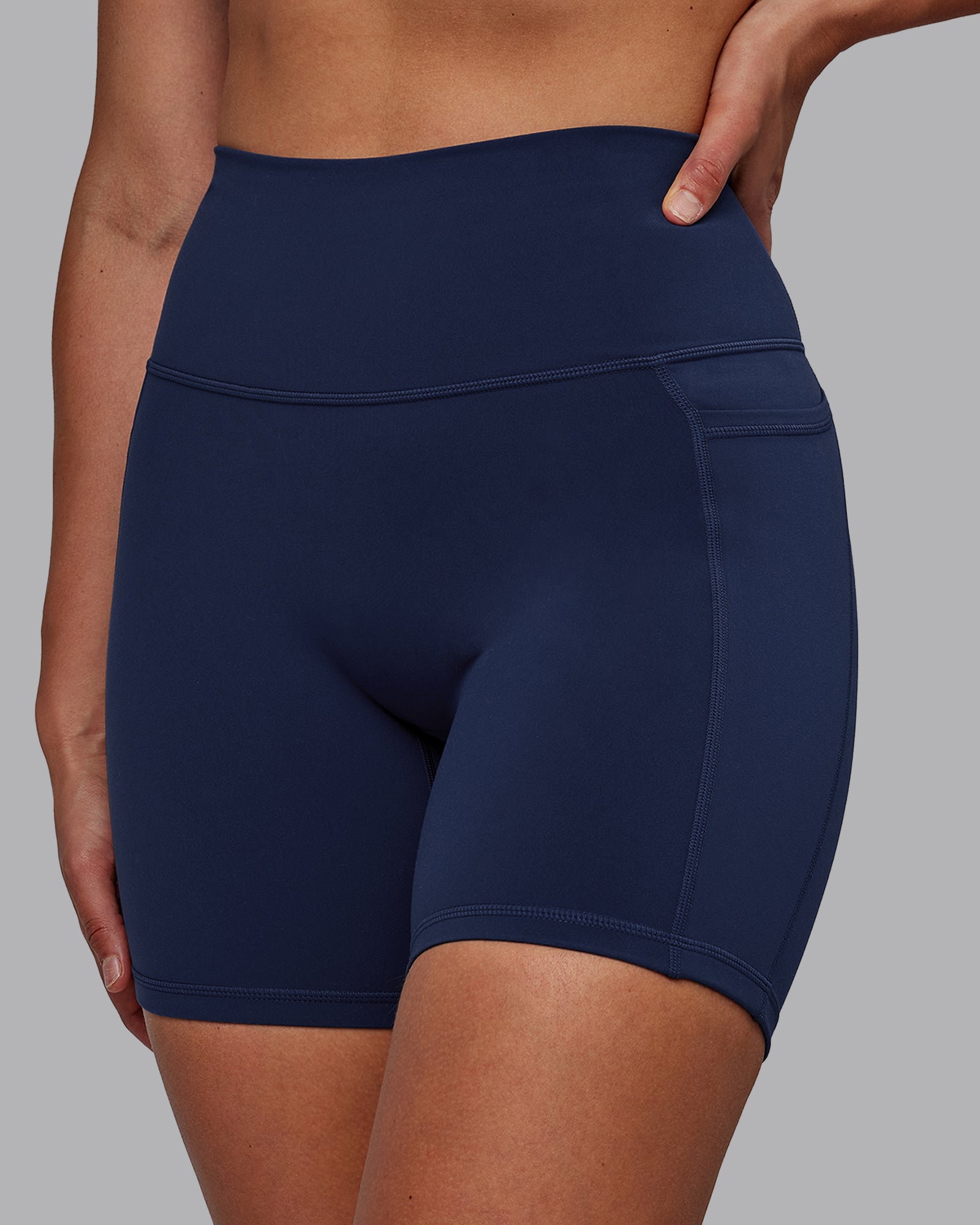 Woman wearing Fusion Ultra High-Rise 6" Short Pockets - Future Navy | Model:Sophie | Size:S