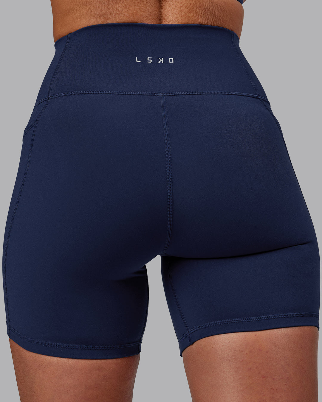 Woman wearing Fusion Ultra High-Rise 6&quot; Short Pockets - Future Navy | Model:Sophie | Size:S