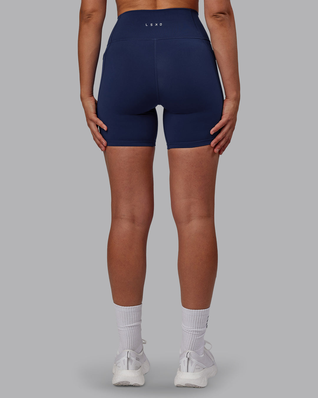Woman wearing Fusion Ultra High-Rise 6&quot; Short Pockets - Future Navy | Model:Sophie | Size:S