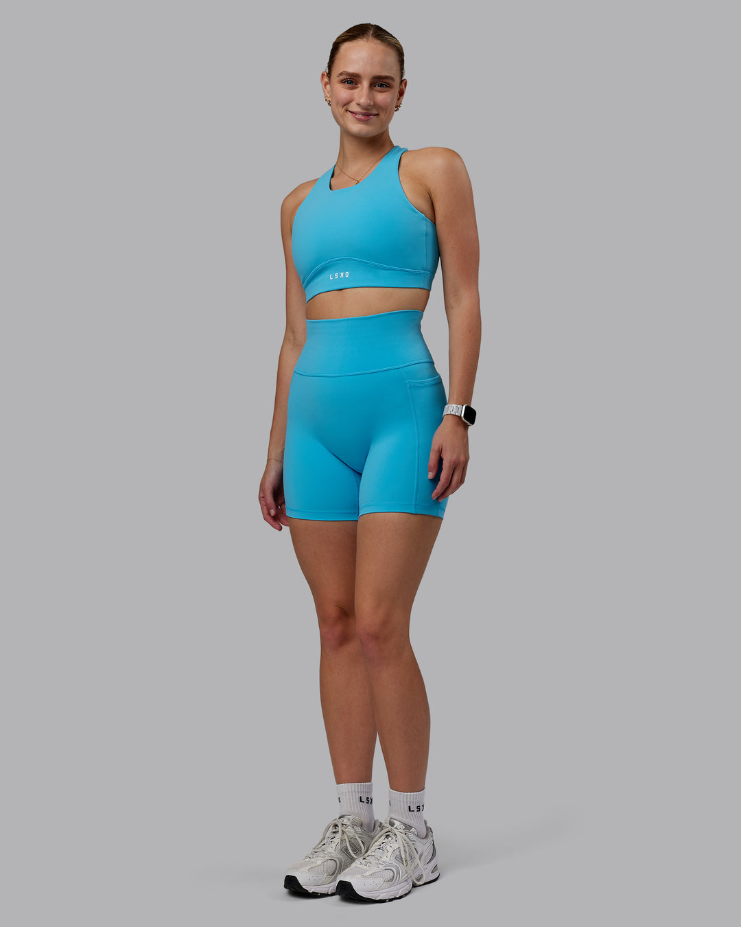Woman wearing Fusion Ultra High-Rise 6&quot; Short Pockets - Pacific Blue | Model:Lillie | Size:S