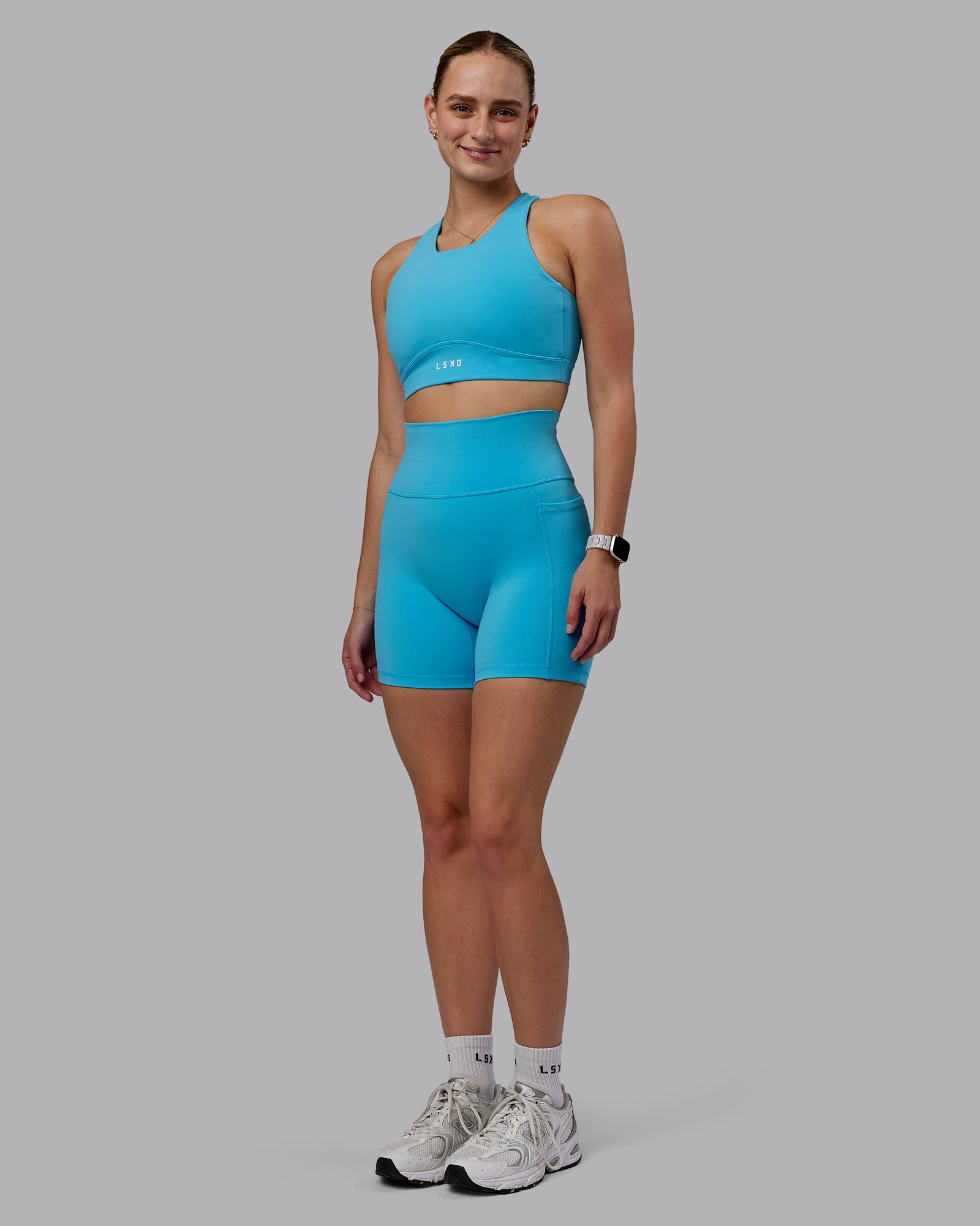 Woman wearing Fusion Ultra High-Rise 6" Short Pockets - Pacific Blue | Model:Lillie | Size:S