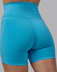 Woman wearing Fusion Ultra High-Rise 6" Short Pockets - Pacific Blue | Model:Lillie | Size:S