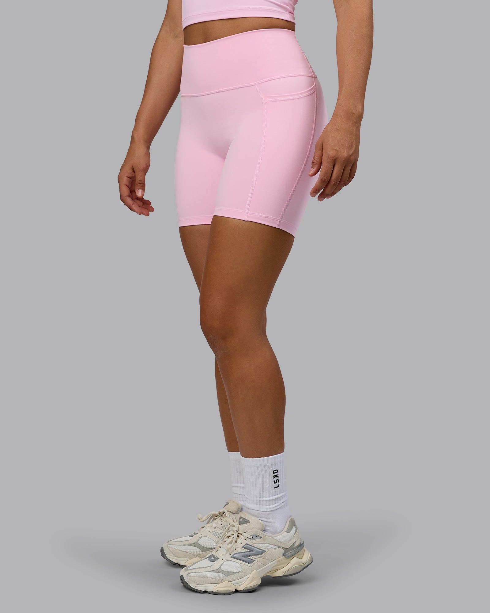 Woman wearing Fusion Ultra High-Rise 6" Short Pockets - Pale Pink | Model:Sophie | Size:S
