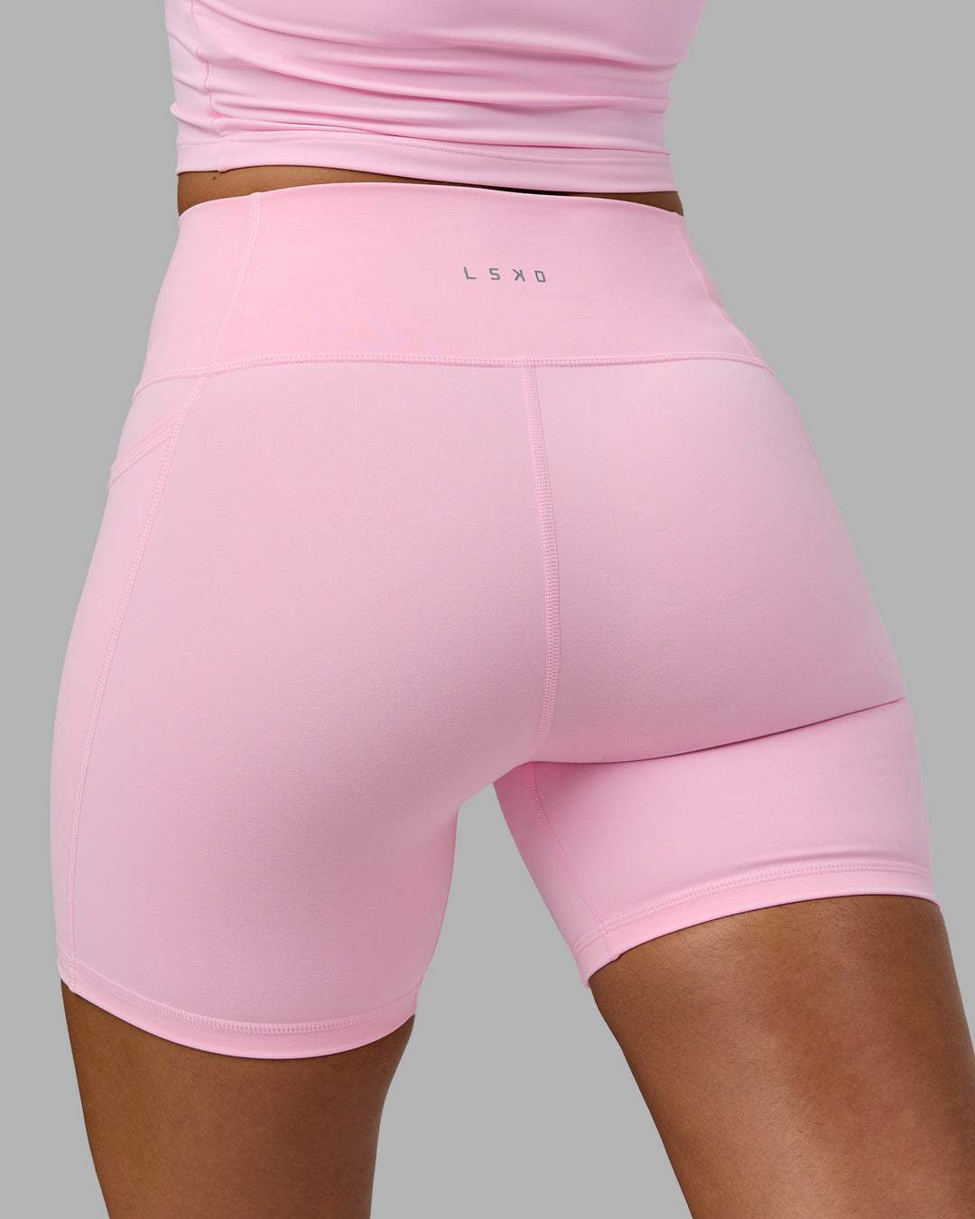 Woman wearing Fusion Ultra High-Rise 6&quot; Short Pockets - Pale Pink | Model:Sophie | Size:S