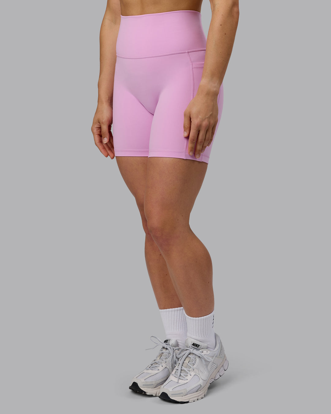 Woman wearing Fusion Ultra High-Rise 6" Short Pockets - Pastel Orchid | Model:Zoe | Size:S
