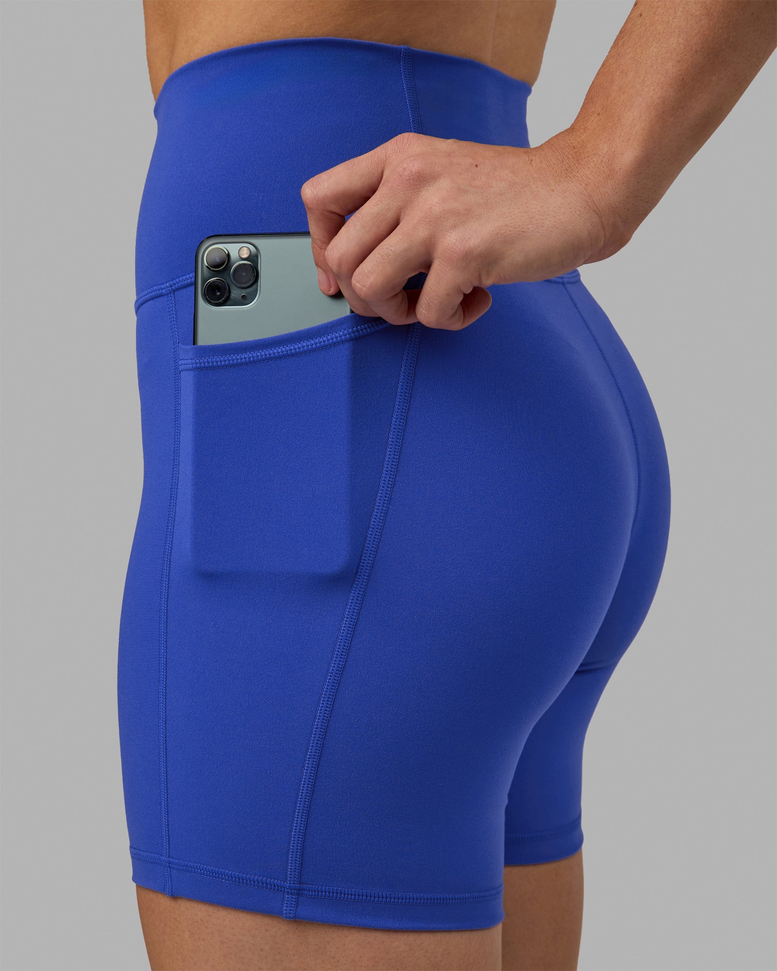 Woman wearing Fusion Ultra High-Rise 6" Short Pockets - Power Cobalt | Model:Hannah | Size:S