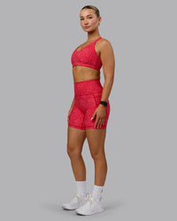Woman wearing Fusion Ultra High-Rise 6" Short Pockets - Red Vitality Print | Model:Halle | Size:S