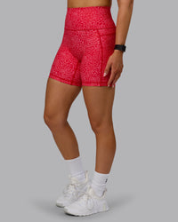 Woman wearing Fusion Ultra High-Rise 6" Short Pockets - Red Vitality Print | Model:Halle | Size:S